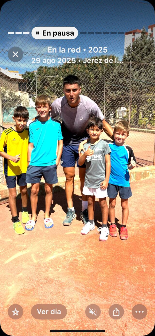 Entrenador con un grupo de alumnos tras la clase de tenis